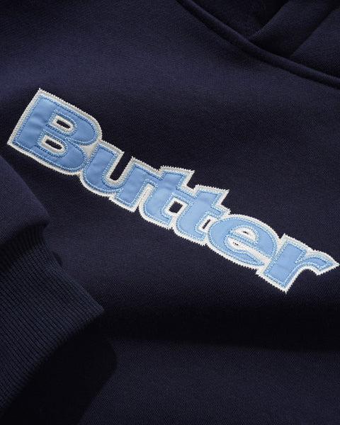 Butter plaid logo applique navy pullover hood sweater with plaid detailing and front logo applique