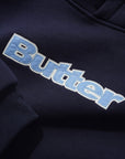 Butter plaid logo applique navy pullover hood sweater with plaid detailing and front logo applique