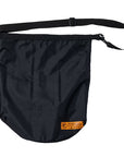 ANTIHERO Hecho Por Skate dry bag in black with orange details, flat product view